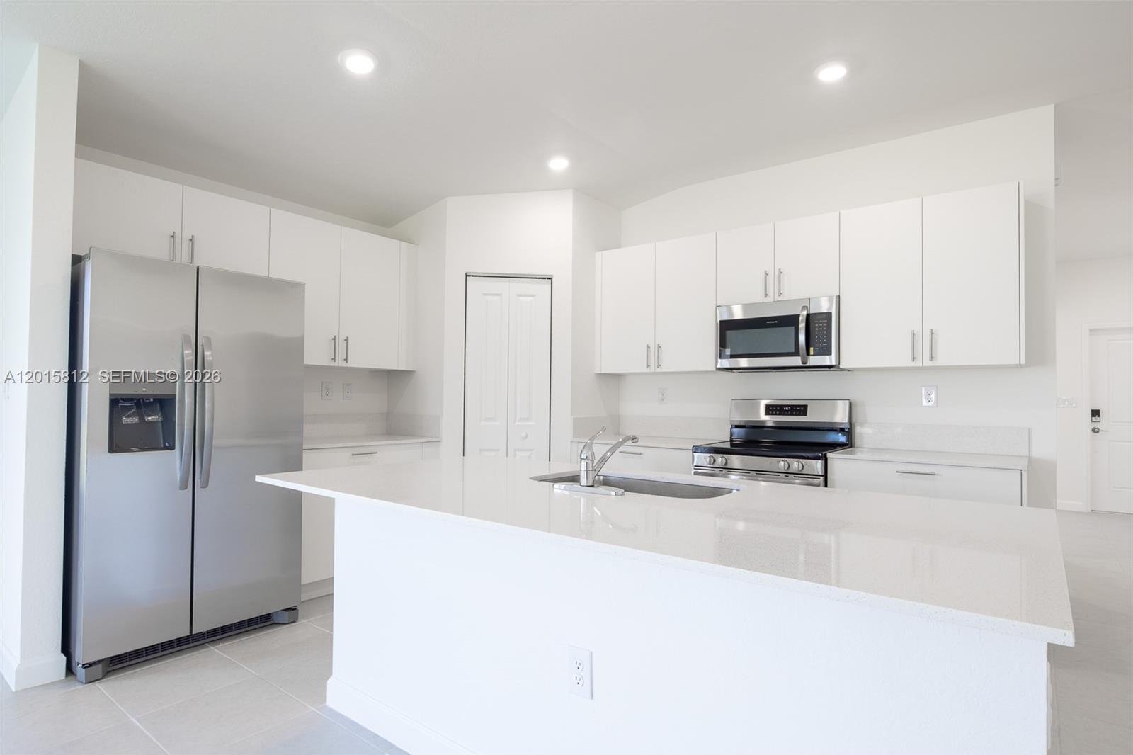 17564 Southwest 285th Street Homestead, FL 33030 - Photo 9 of 42 a kitchen with stainless steel appliances a stove a sink a refrigerator a microwave and cabinets