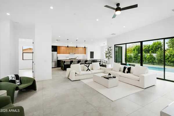 a living room with furniture tv and large window