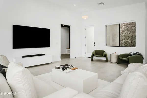 a living room with furniture ceiling fan and a rug