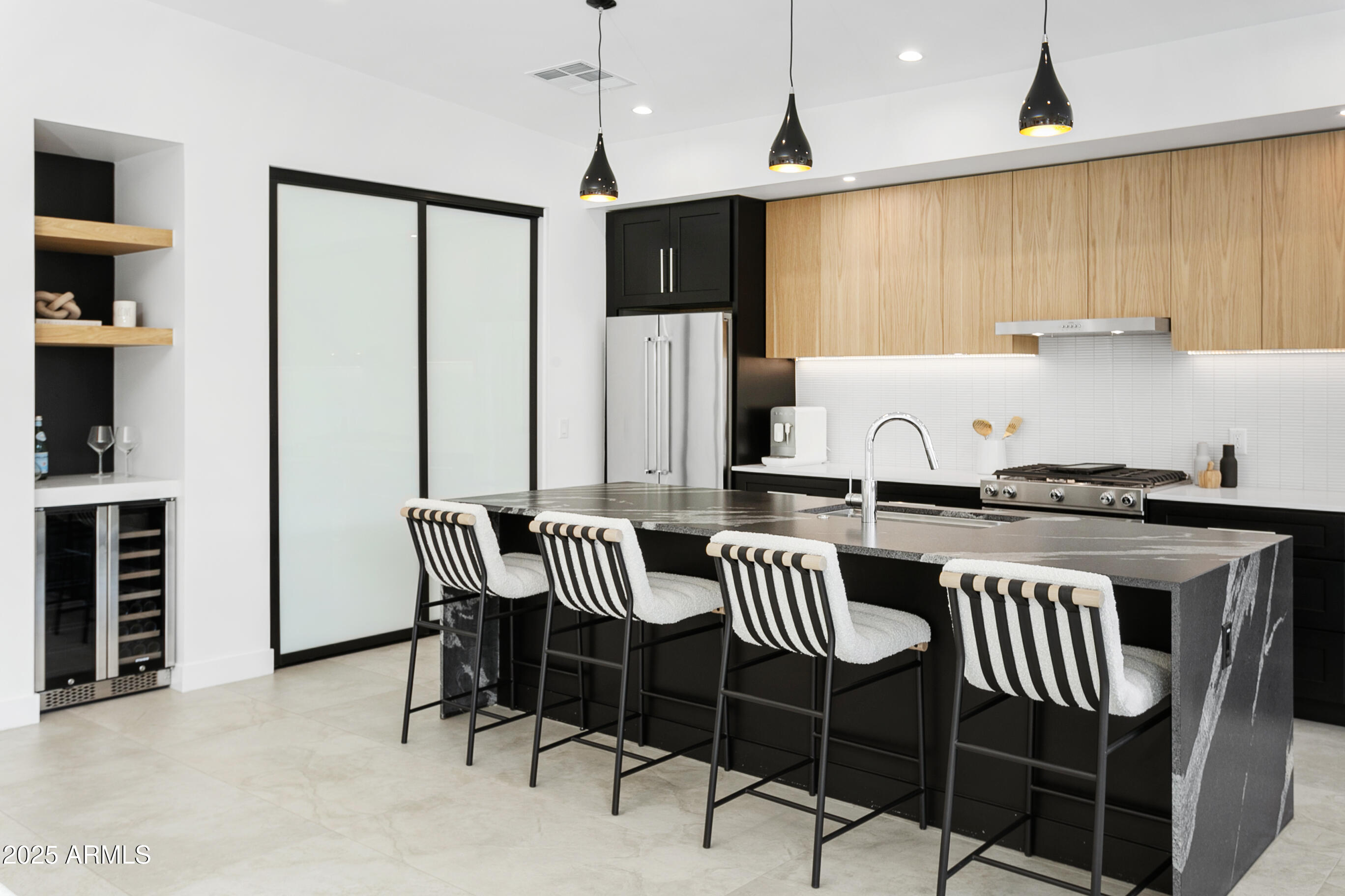 4002 North 33rd Place Phoenix, AZ 85018 - Photo 27 of 80 a kitchen with stainless steel appliances granite countertop a stove a refrigerator a dining table and chairs with wooden floor