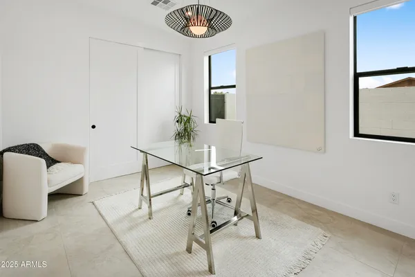 a living room with furniture pool table and floor to ceiling windows