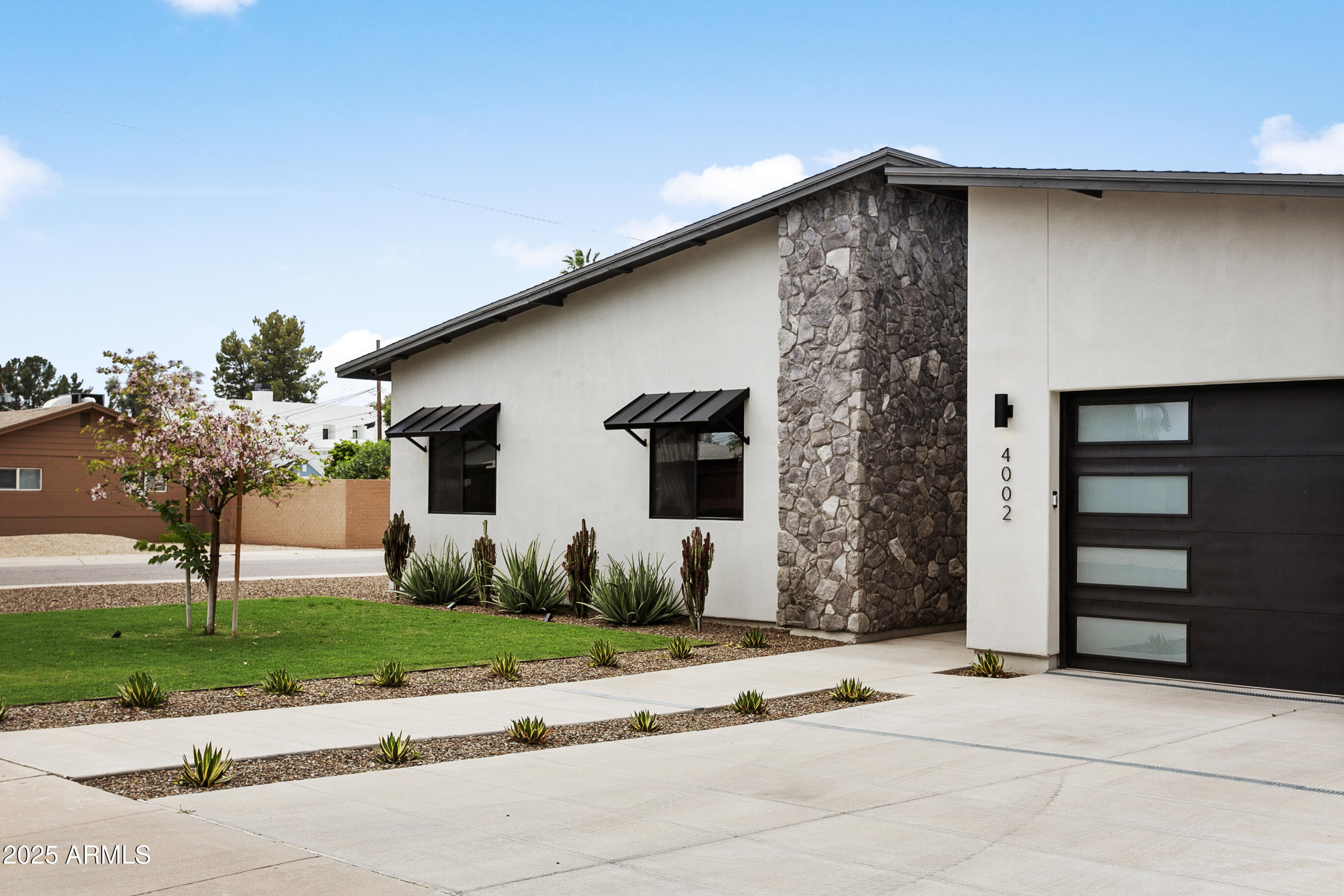 4002 North 33rd Place Phoenix, AZ 85018 - Photo 75 of 80 a front view of a house with a yard and garage