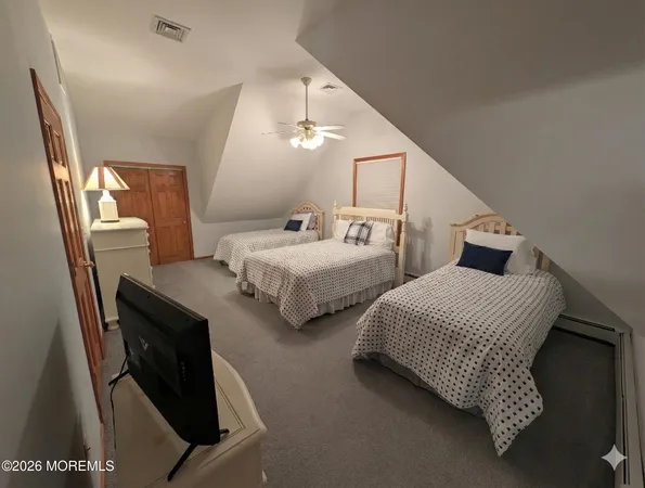 a bedroom with two beds and painted walls