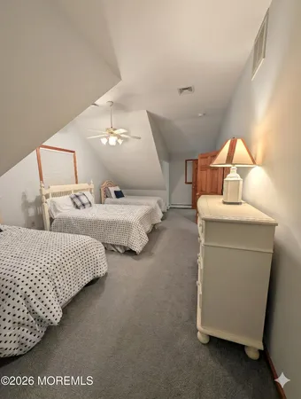 a living room with two bed and a lamp