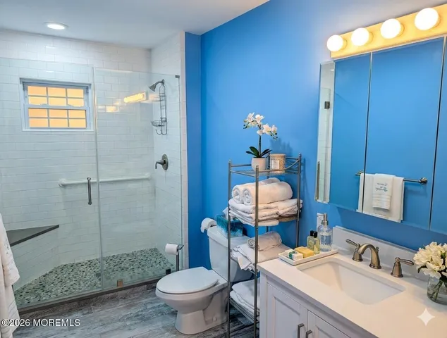 a bathroom with a sink toilet and shower
