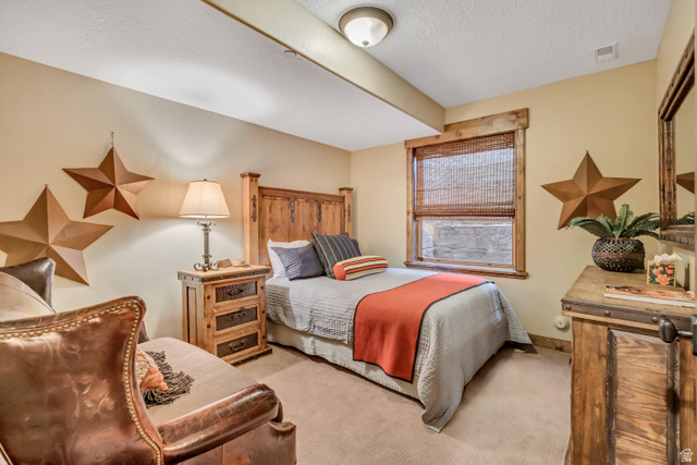 9049 Timphaven Road Sundance, UT 84604 - Photo 51 of 63 Bedroom featuring light colored carpet and a textured ceiling