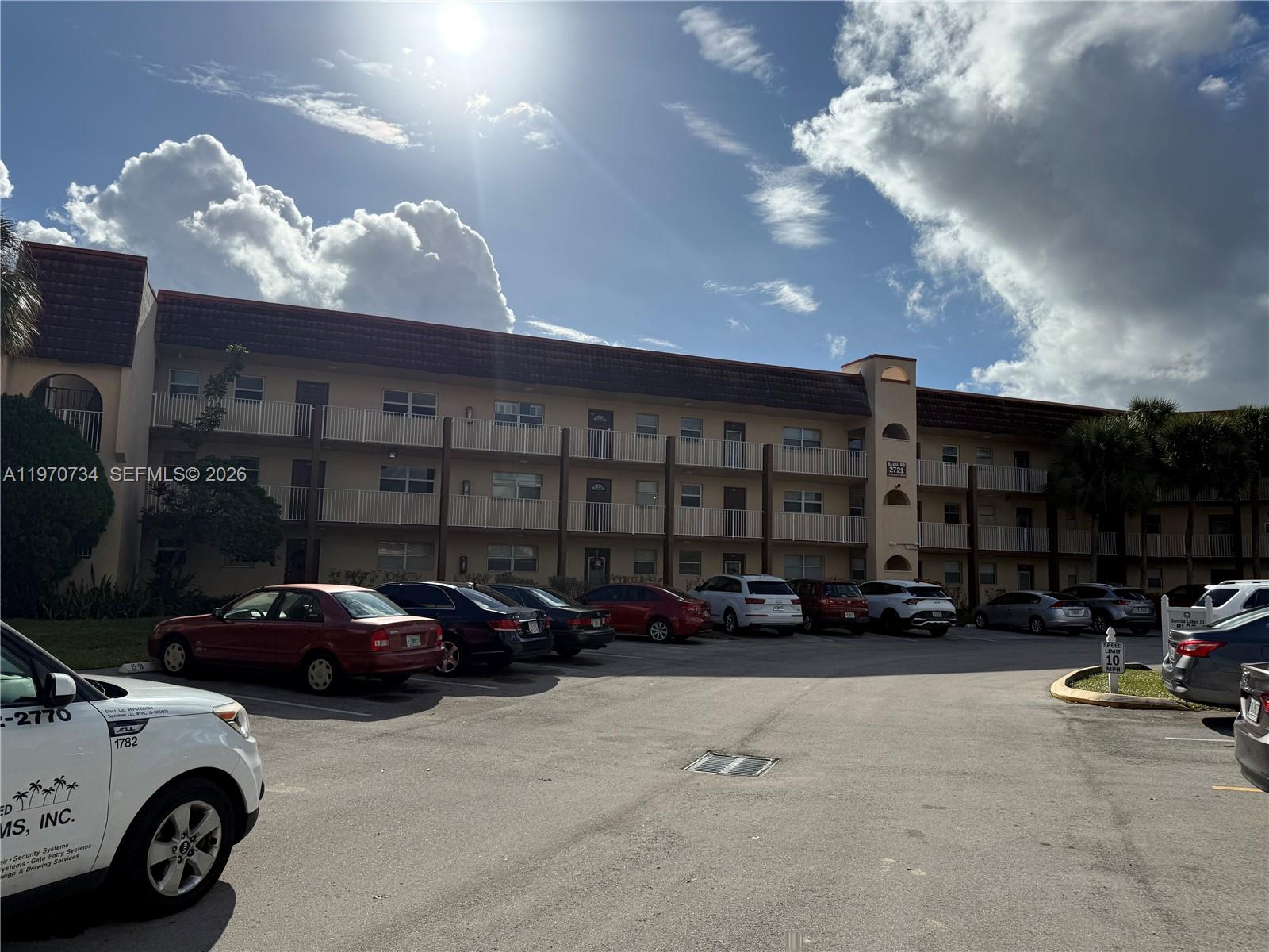 2721 North Pine Island Road, Unit 202 Sunrise, FL 33322 - Photo 1 of 12 a view of parking with cars parked