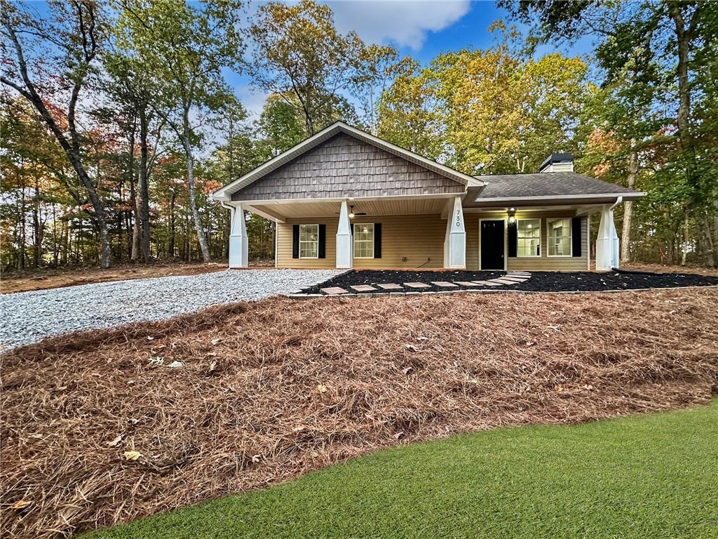 a front view of house with yard and trees