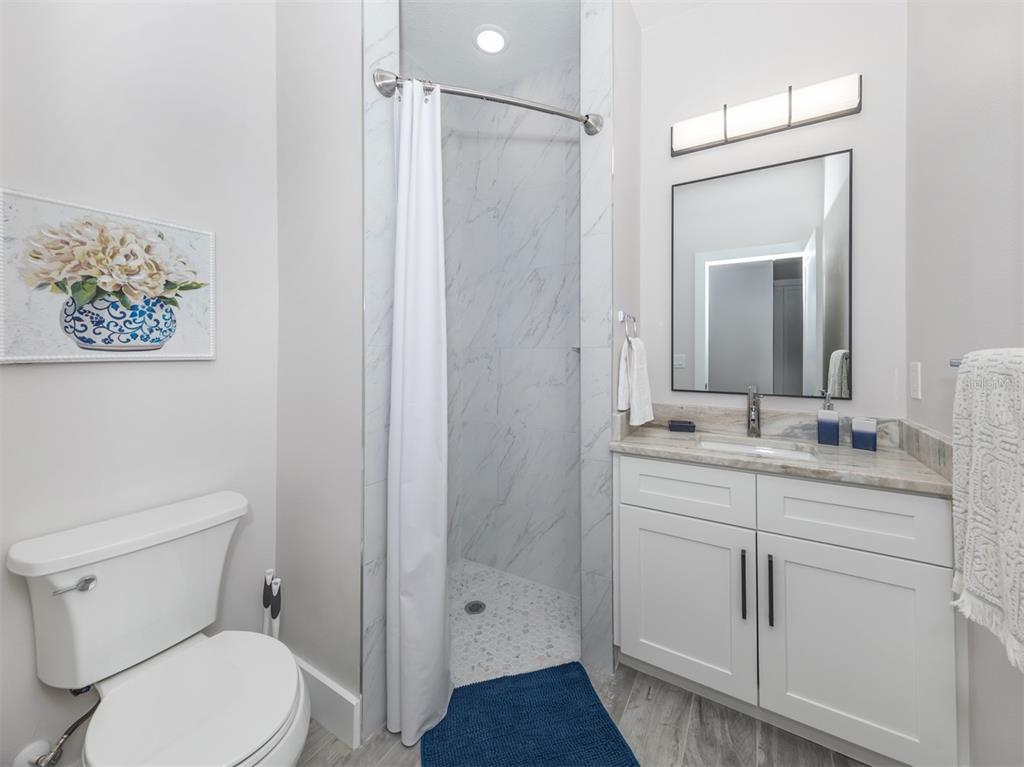 17566 De Miranda Avenue North Port, FL 34287 - Photo 15 of 94 a bathroom with a toilet a sink and shower