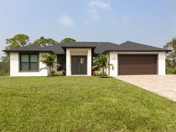 a front view of a house with garden