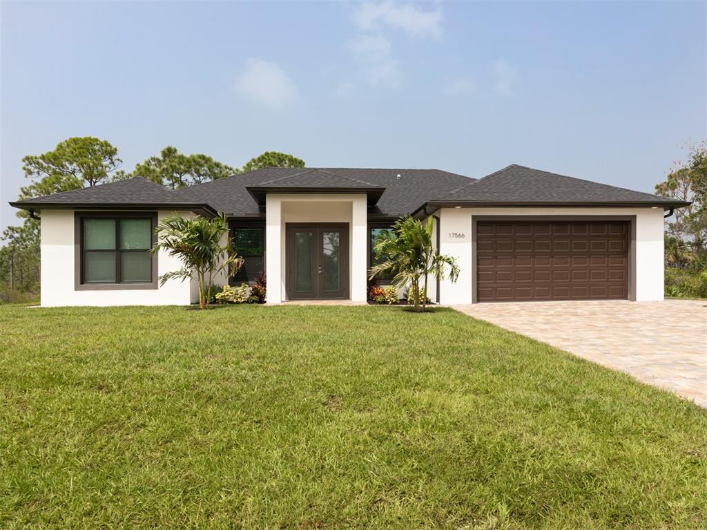17566 De Miranda Avenue North Port, FL 34287 - Photo 2 of 94 a front view of a house with garden