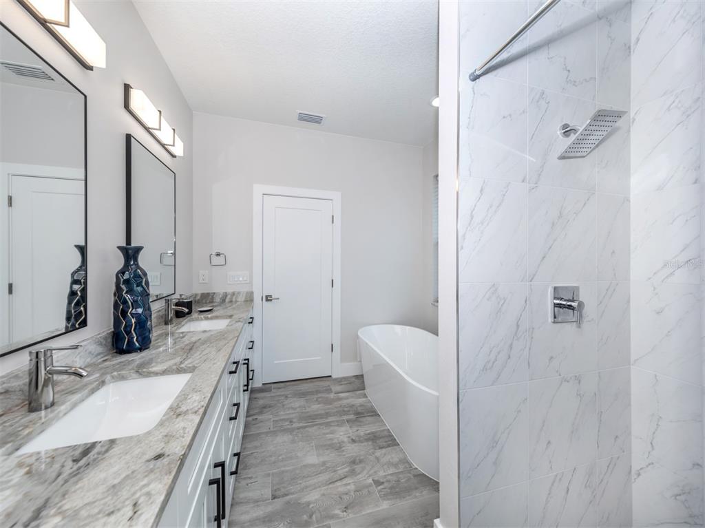 17566 De Miranda Avenue North Port, FL 34287 - Photo 23 of 94 a bathroom with a tub sink and mirror