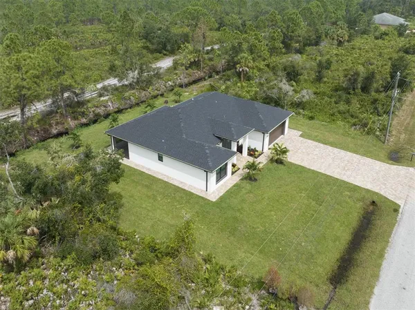 a view of a house with backyard porch and sitting area