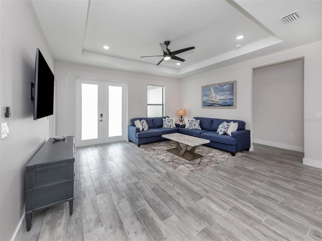 17566 De Miranda Avenue North Port, FL 34287 - Photo 3 of 94 a living room with furniture and a flat screen tv