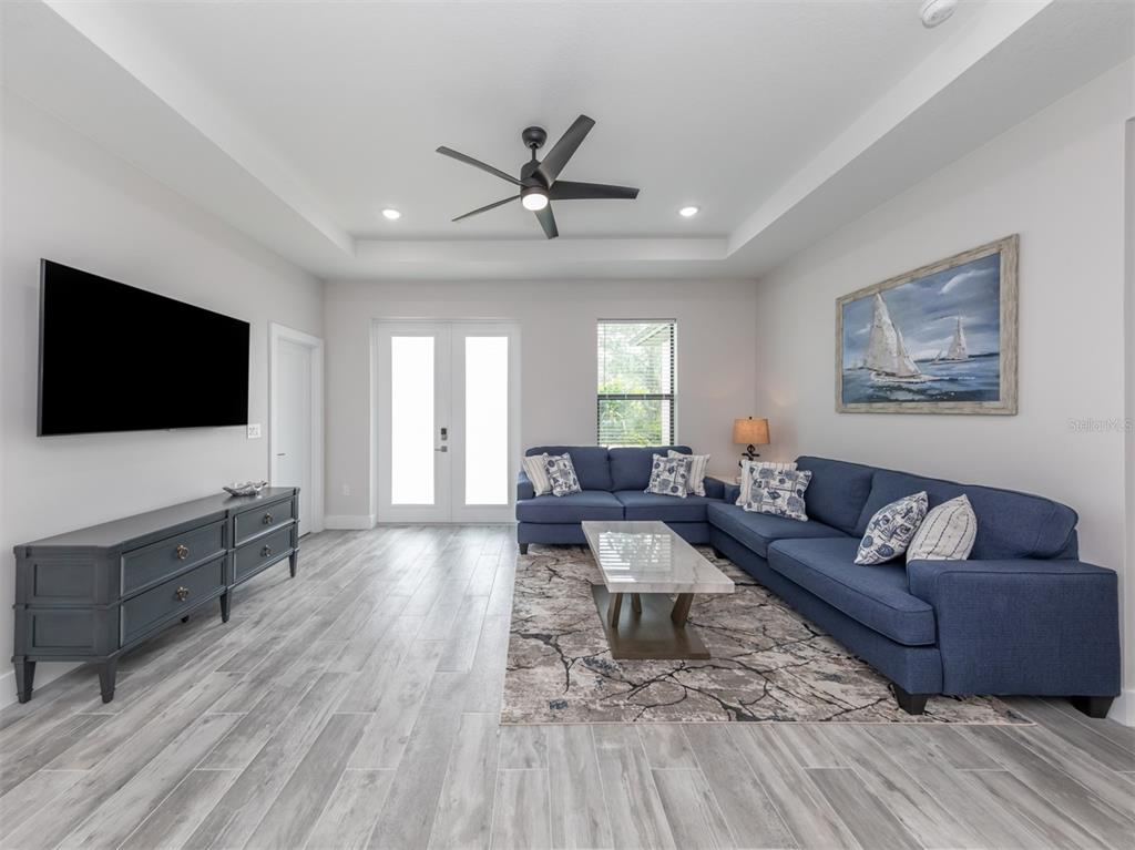 17566 De Miranda Avenue North Port, FL 34287 - Photo 4 of 94 a living room with furniture and a flat screen tv