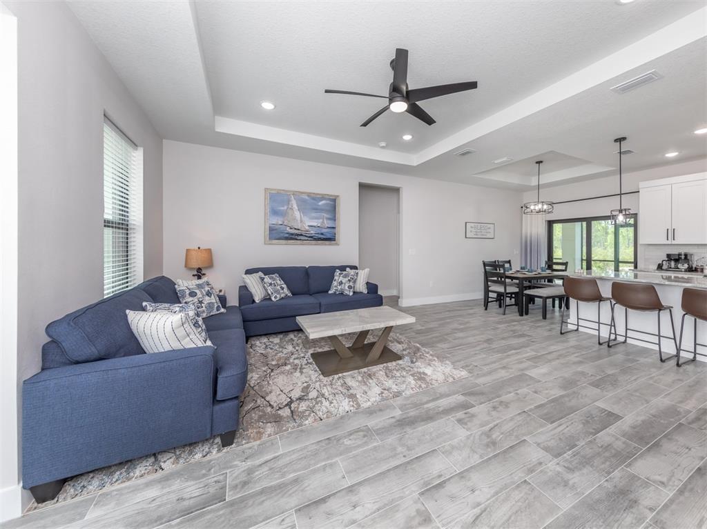 17566 De Miranda Avenue North Port, FL 34287 - Photo 8 of 94 a living room with furniture and a view of kitchen