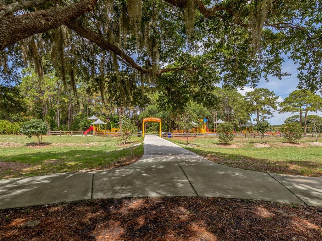 17566 De Miranda Avenue North Port, FL 34287 - Photo 82 of 94 a view of yard with swimming pool and green space