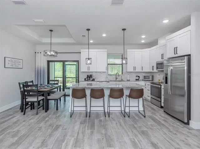 a kitchen with kitchen island granite countertop a counter space stainless steel appliances and cabinets