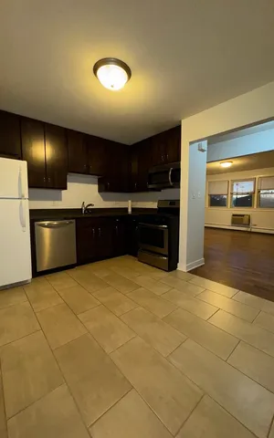 a large kitchen with cabinets and a stove top oven