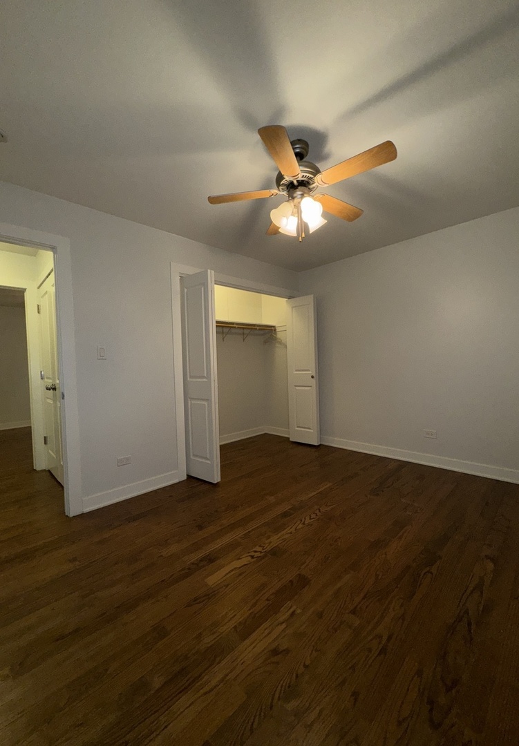 4612 Forest Avenue, Unit 8 Brookfield, IL 60513 - Photo 5 of 10 an empty room with wooden floor and windows