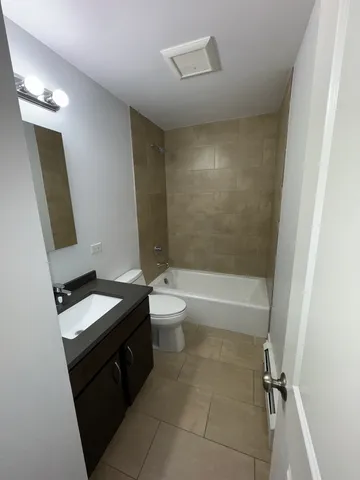 a bathroom with a toilet a sink and bathtub