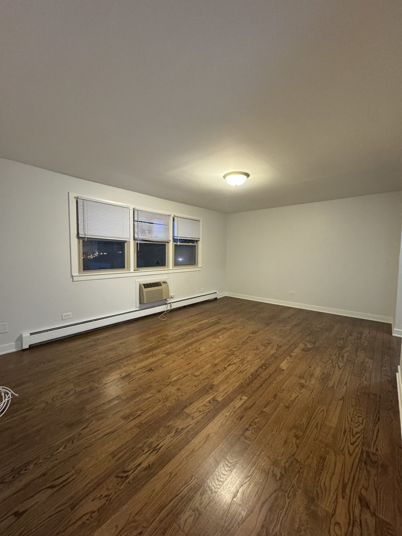 4612 Forest Avenue, Unit 8 Brookfield, IL 60513 - Photo 10 of 10 a view of an empty room with wooden floor and a window