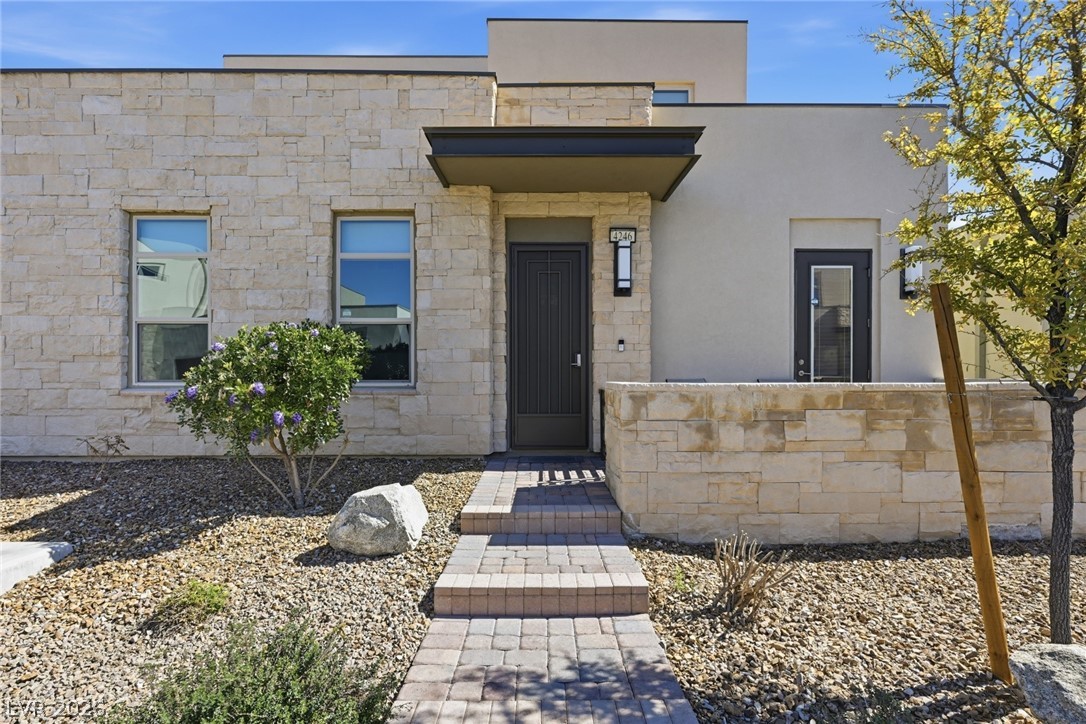 4246 Swift Street Las Vegas, NV 89135 - Photo 5 of 71 Property entrance with stucco siding and stone siding