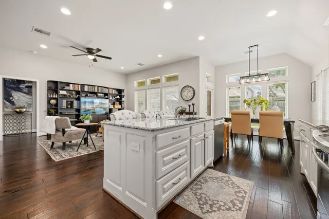 a kitchen with stainless steel appliances granite countertop a stove and cabinets