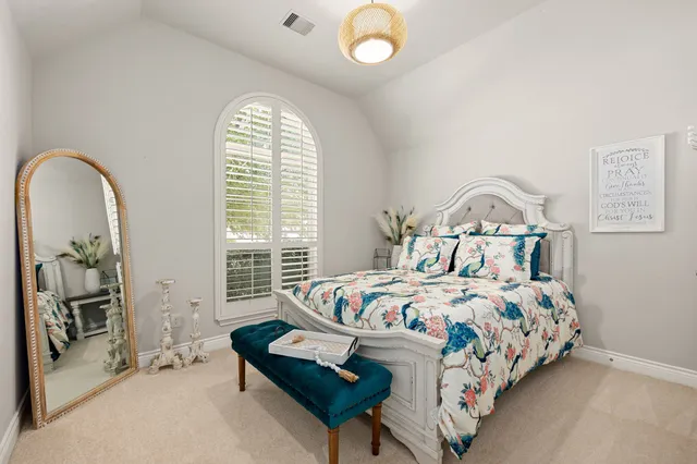 a bedroom with bed and a window