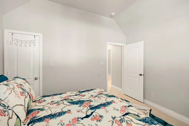 a bedroom with a bed and a mirror