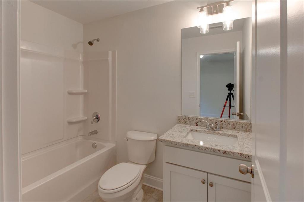 41 Woodland Road Covington, GA 30016 - Photo 44 of 46 a bathroom with a sink a toilet and shower