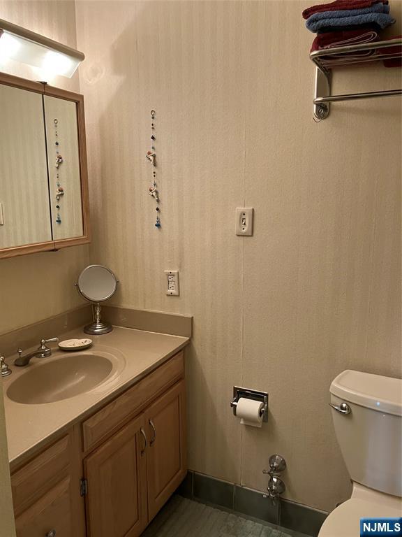 280 Prospect Avenue, Unit 11H Hackensack, NJ 07601 - Photo 13 of 20 a bathroom with a sink toilet and vanity