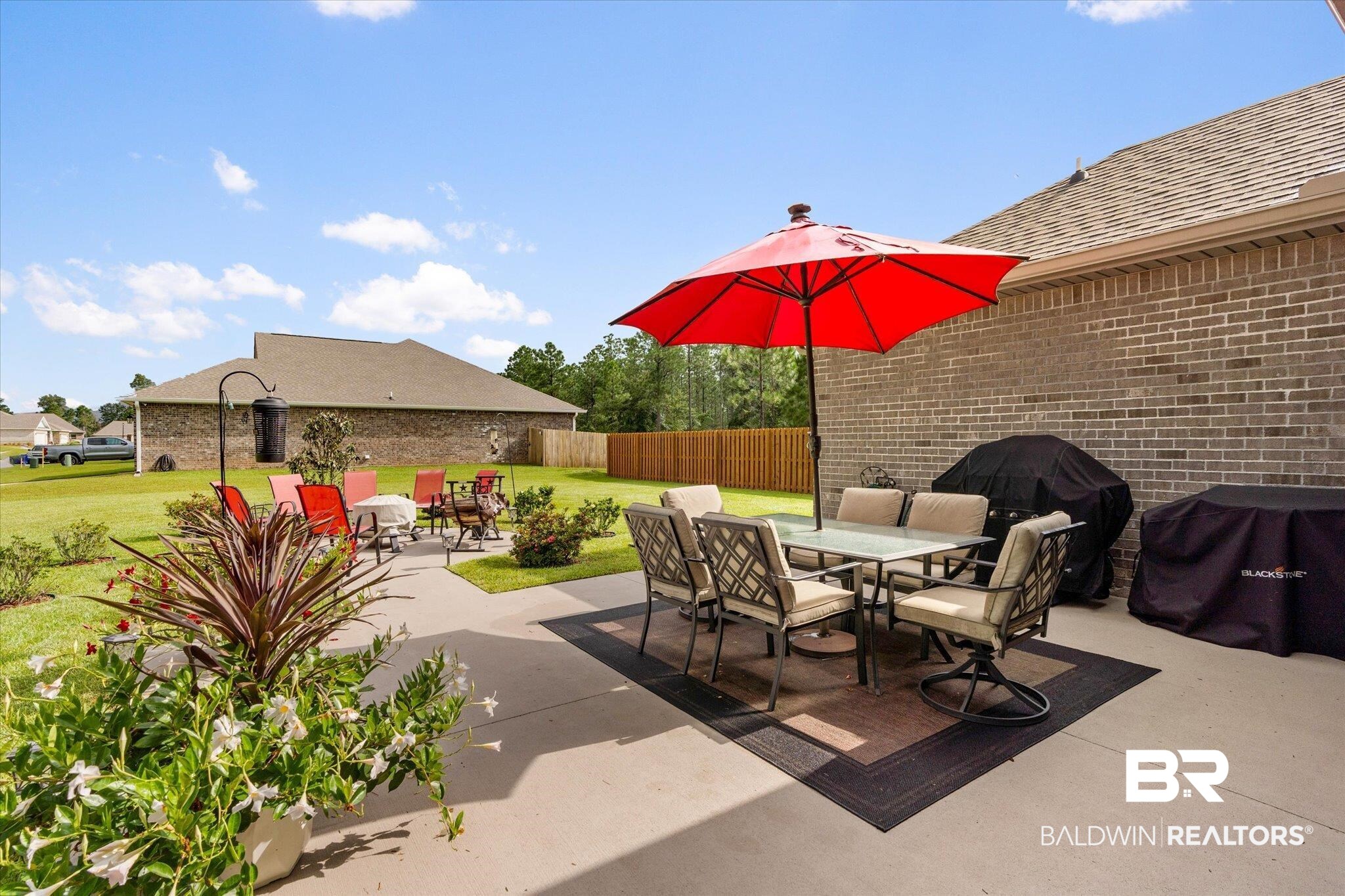 1786 Vivace Drive Foley, AL 36535 - Photo 17 of 21 Fenced backyard featuring outdoor dining space, a grill, and a patio area