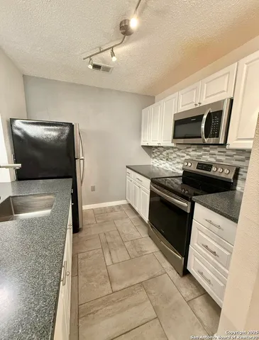 a spacious bathroom with a sink a mirror and a bathtub