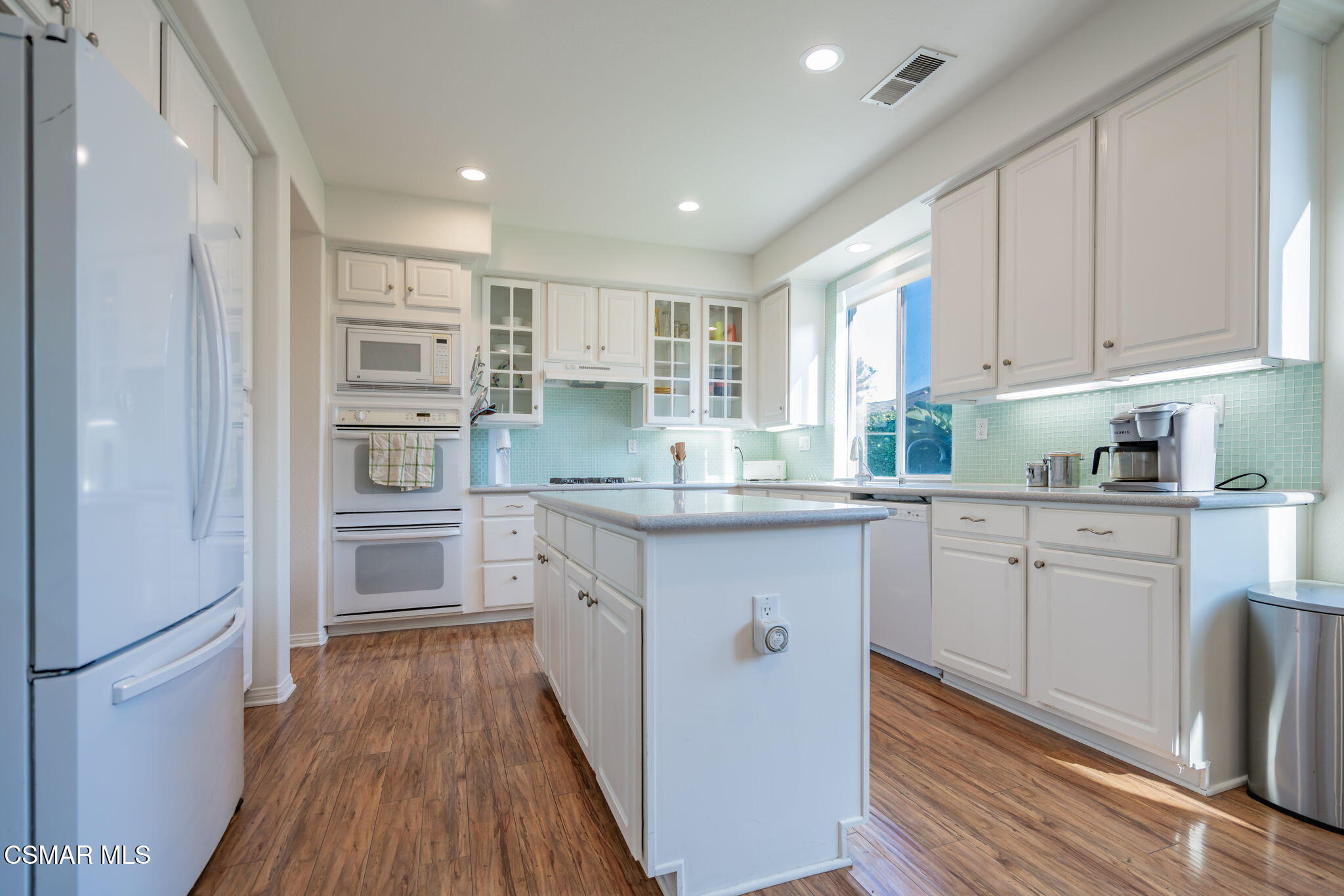 791 Eisenhower Way Simi Valley, CA 93065 - Photo 11 of 59 a kitchen with stainless steel appliances granite countertop a refrigerator and a stove top oven
