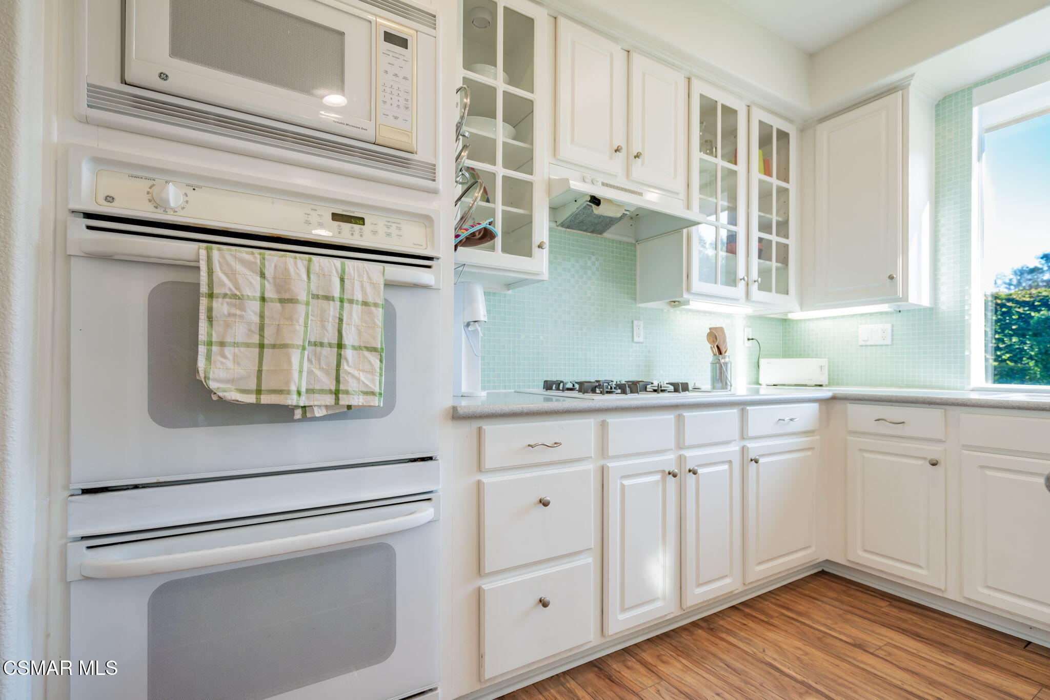 791 Eisenhower Way Simi Valley, CA 93065 - Photo 13 of 59 a kitchen with granite countertop white cabinets and white appliances
