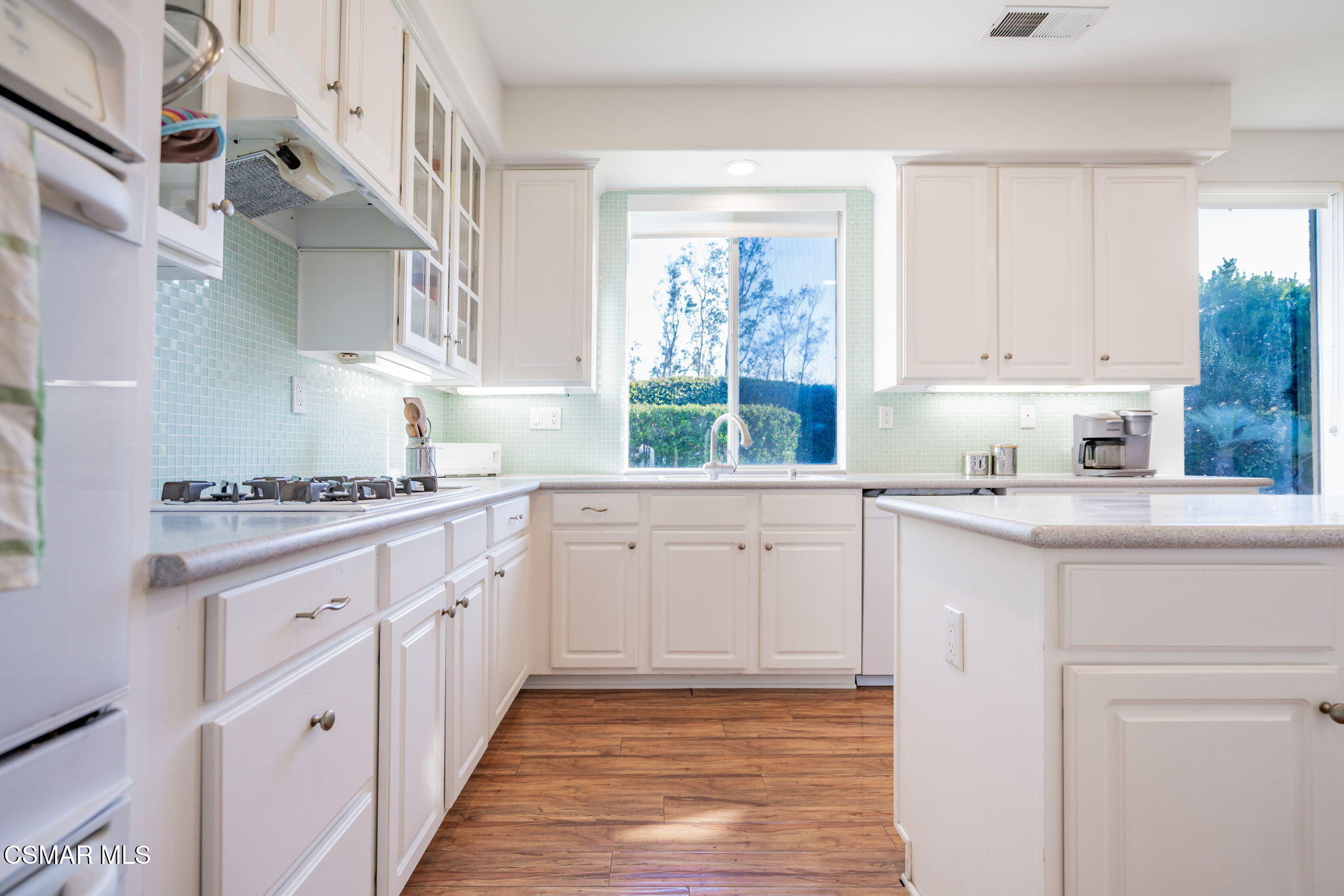 791 Eisenhower Way Simi Valley, CA 93065 - Photo 14 of 59 a kitchen with white cabinets and window