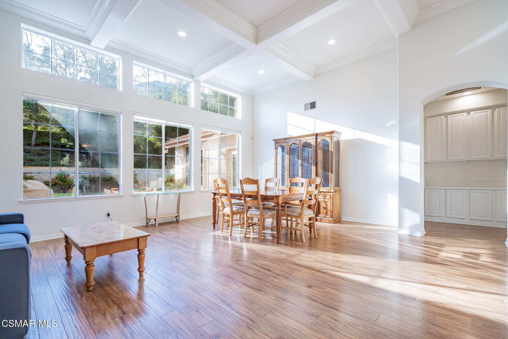 791 Eisenhower Way Simi Valley, CA 93065 - Photo 10 of 59 a dining room with wooden floor a chandelier a glass table and chairs