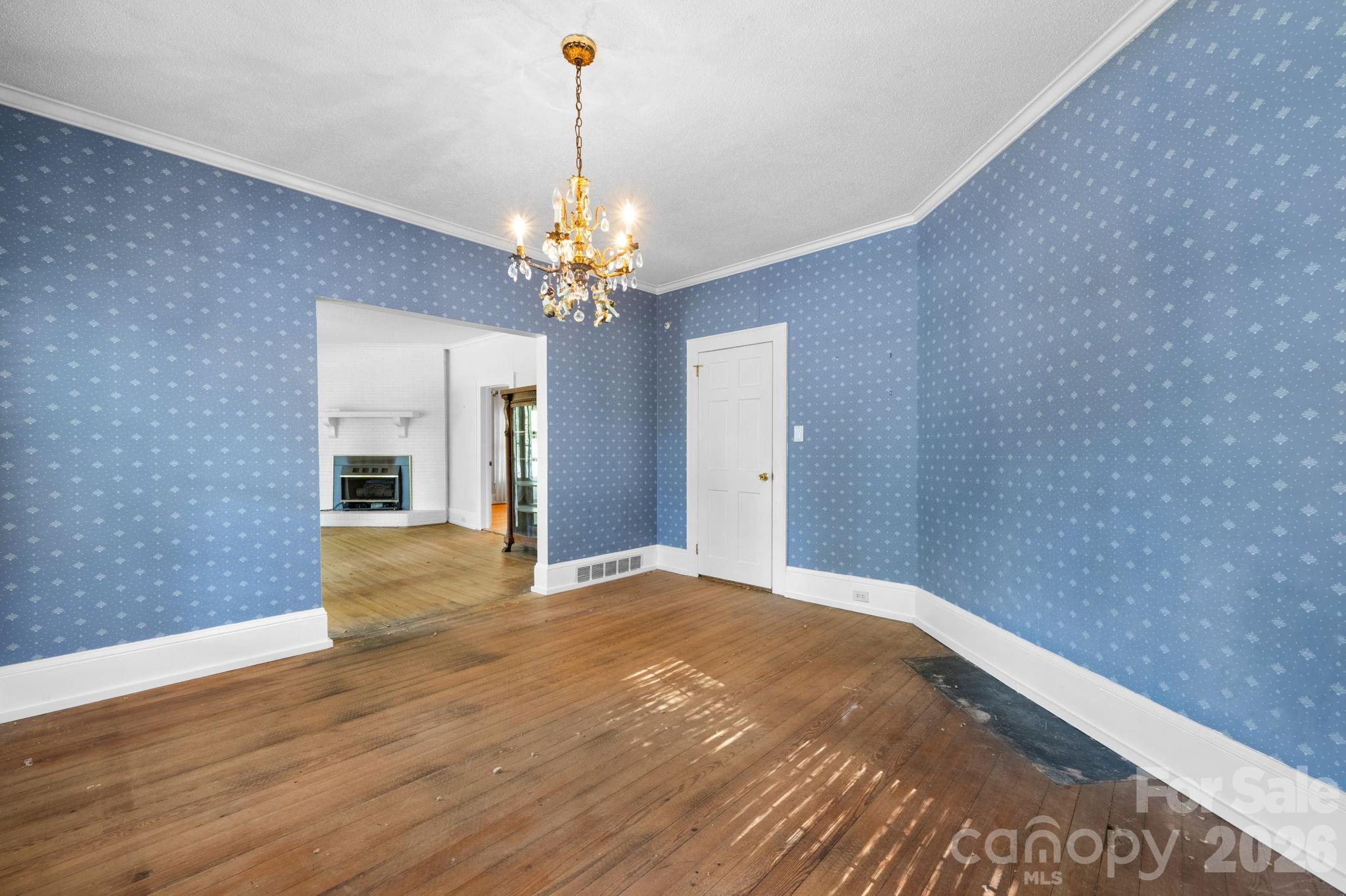 144 Hunter Bridge Road Stony Point, NC 28678 - Photo 14 of 45 a view of a livingroom with a chandelier fan and wooden floor