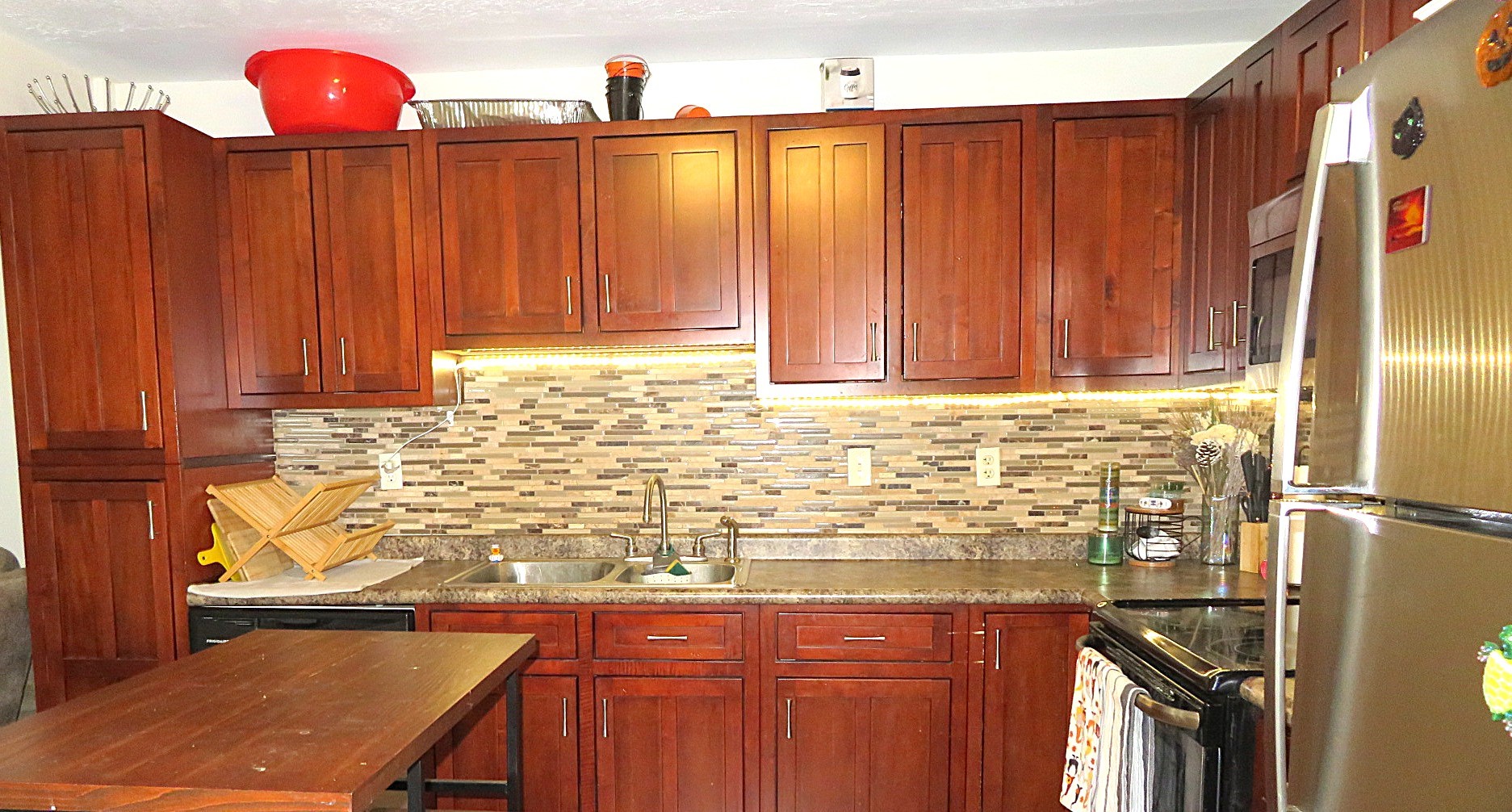 828 Robinson Road La Porte, TX 77571 - Photo 3 of 10 a kitchen with a sink a refrigerator and cabinets