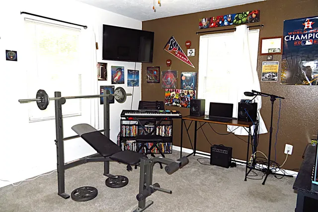 a view of a workspace with furniture and a flat screen tv
