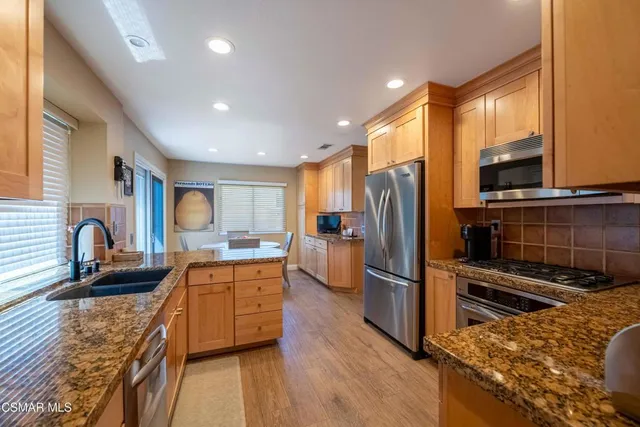 a kitchen with refrigerator cabinets and wooden floor