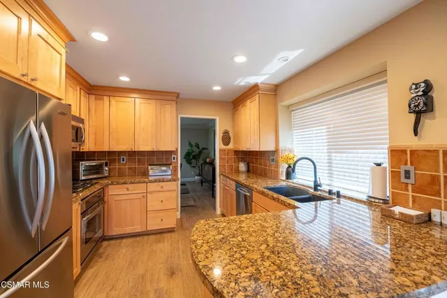 a kitchen with a table chairs sink and microwave