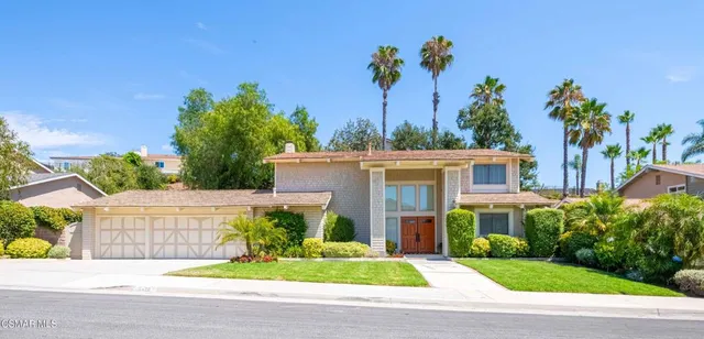 a view of a house with a yard and plants