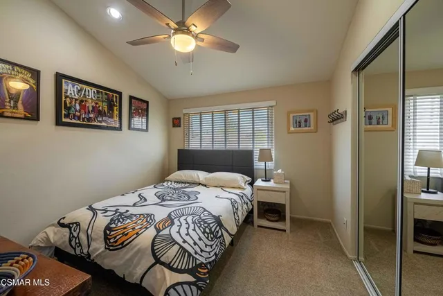 a bathroom with a granite countertop sink a toilet and a large mirror