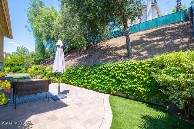 a view of a house with backyard and porch