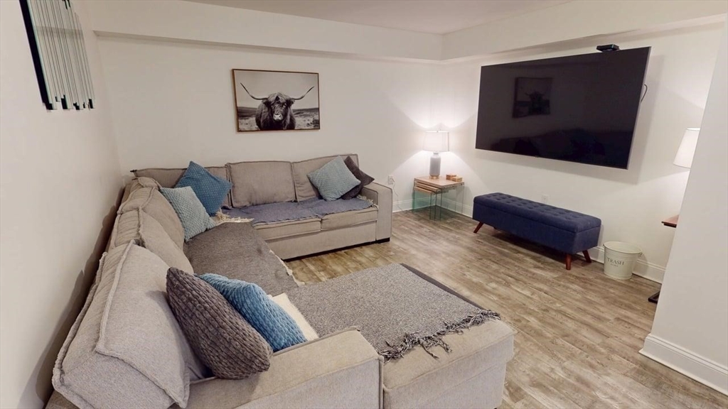 4 Market Street Cambridge, MA 02139 - Photo 21 of 22 a living room with furniture and a flat screen tv