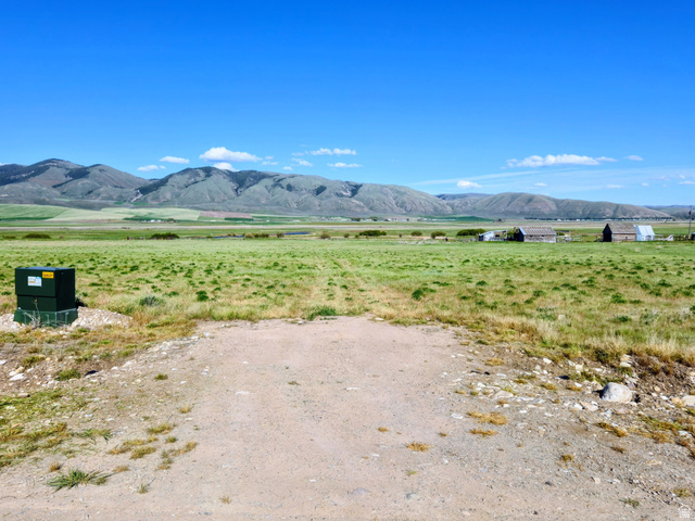 1720 Lower Bern Road, Unit 8 Bern, ID 83220 - Photo 1 of 7 Expansive open land featuring a clear blue sky, distant mountains, and a verdant field