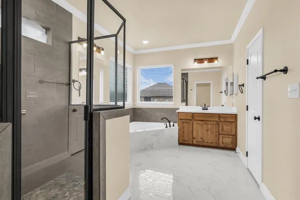 a bathroom with a bathtub shower sink and mirror