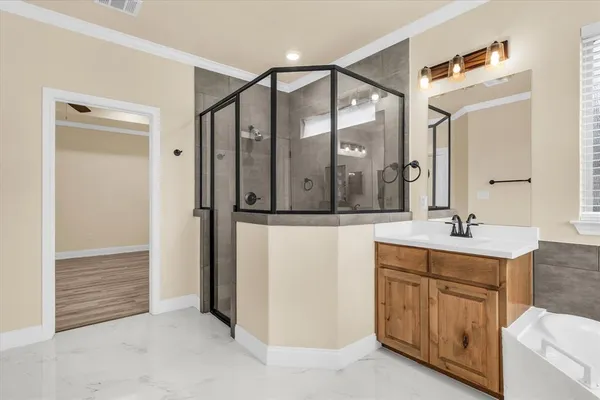 a bathroom with a shower sink and mirror